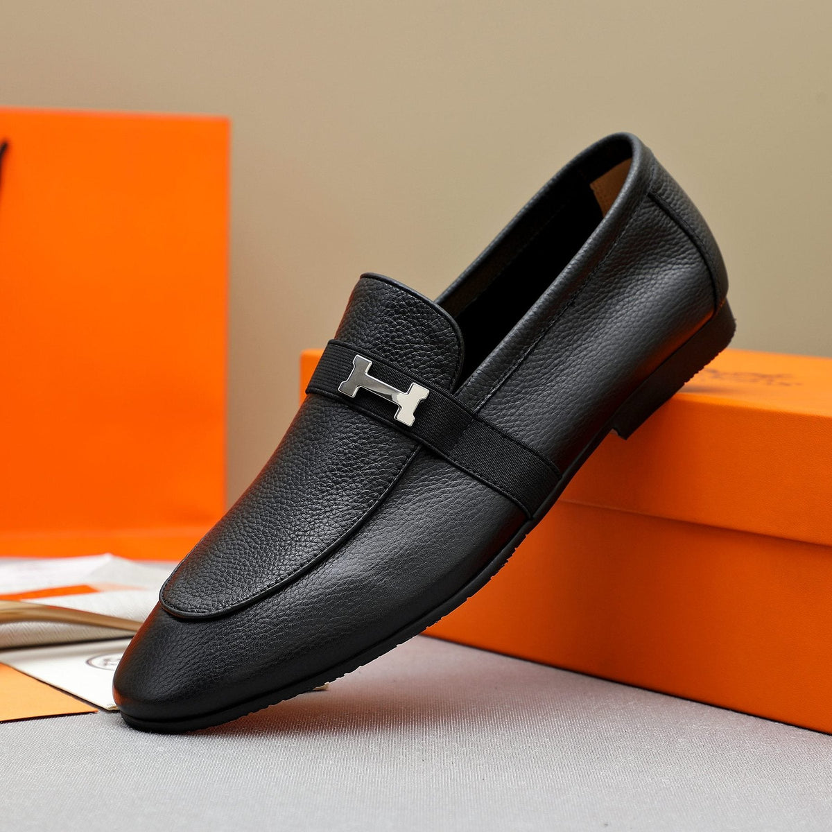 Hermès Black Pebbled Leather H-Hardware Loafers — side