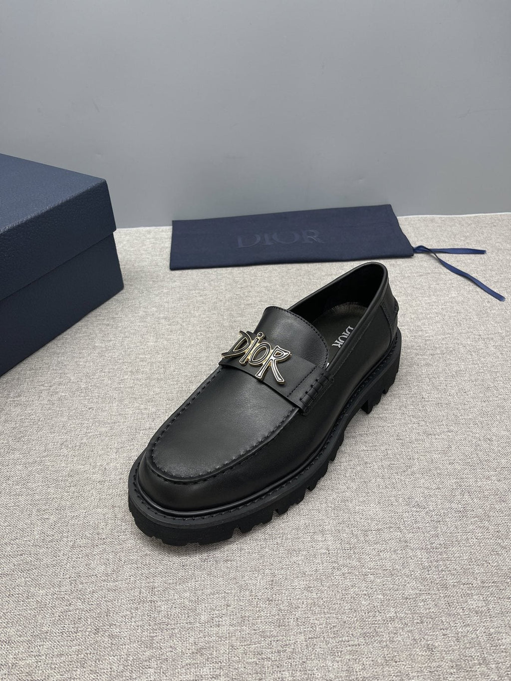 Dior Black Gold-Plaque Slip-On Shoes — side